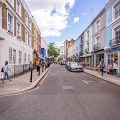Many shops on a street with colourful buildings